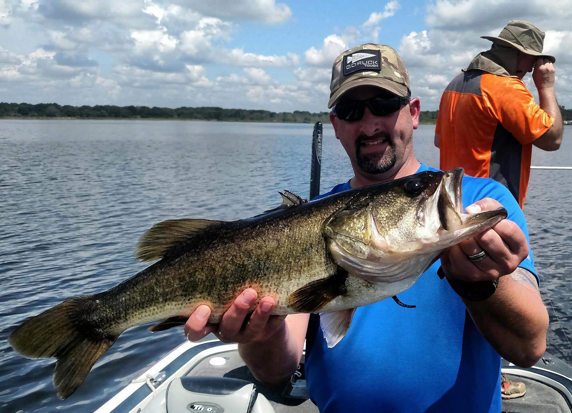 man holding large mouth bass while fishing with Central Florida Bucketmouths