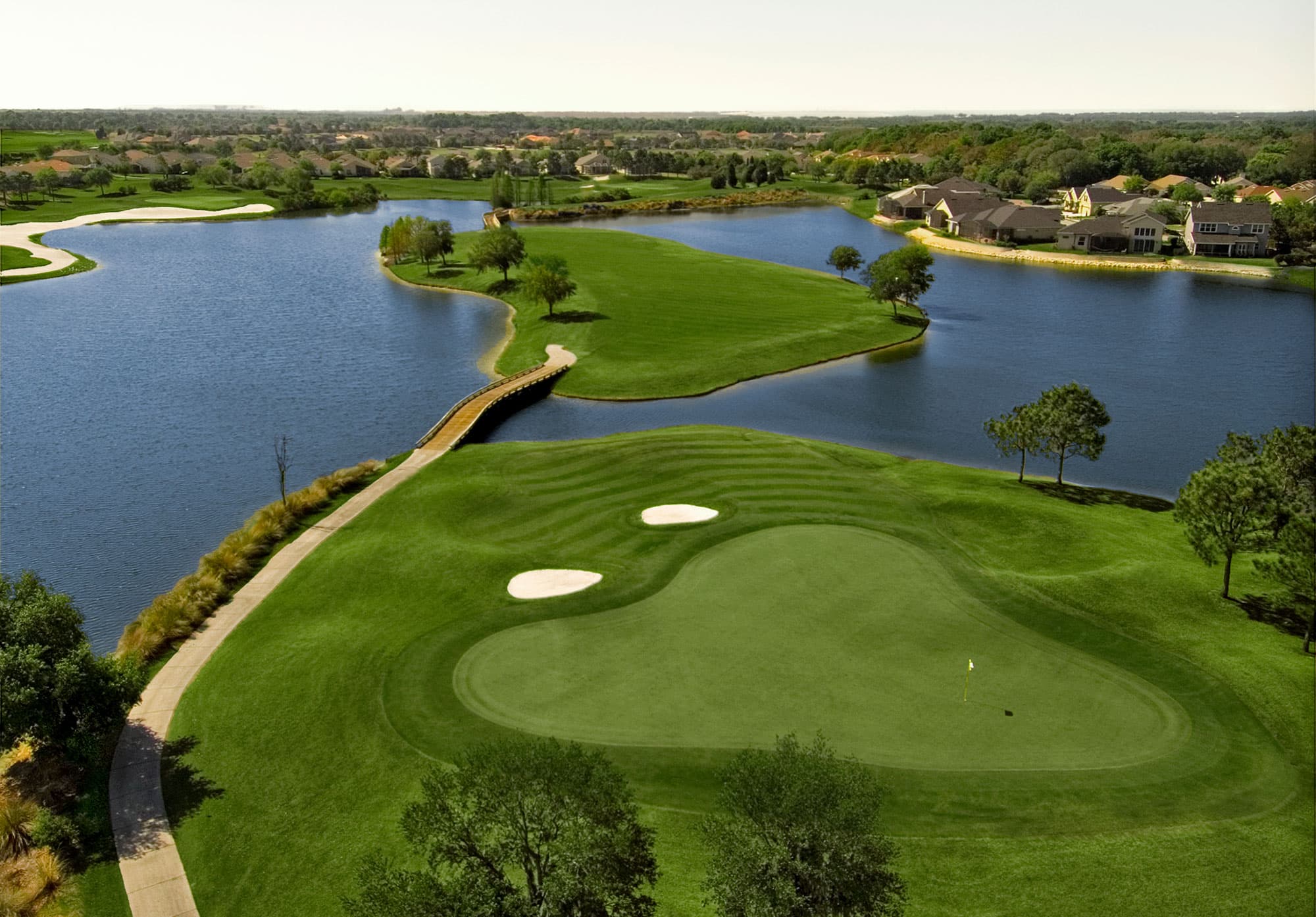 Par 3 hole featuring over the water shot to tee at Eaglebrooke Golf & Country Club in Lakeland, FL