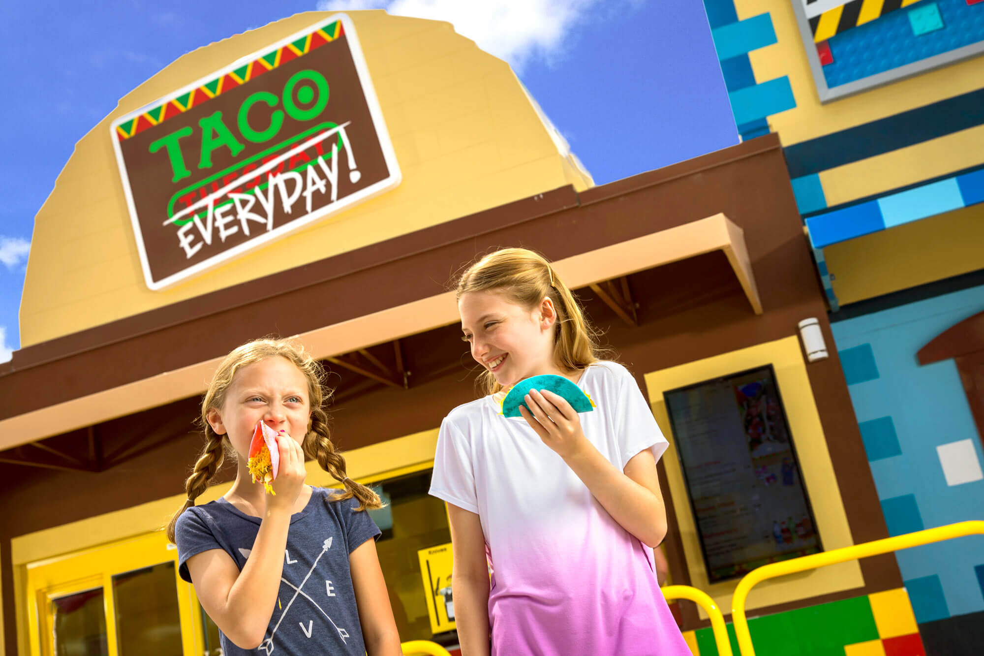 2 girls outside Taco Everyday restaurant in LEGO Movie World at LEGOLAND Florida Resort in Winter Haven