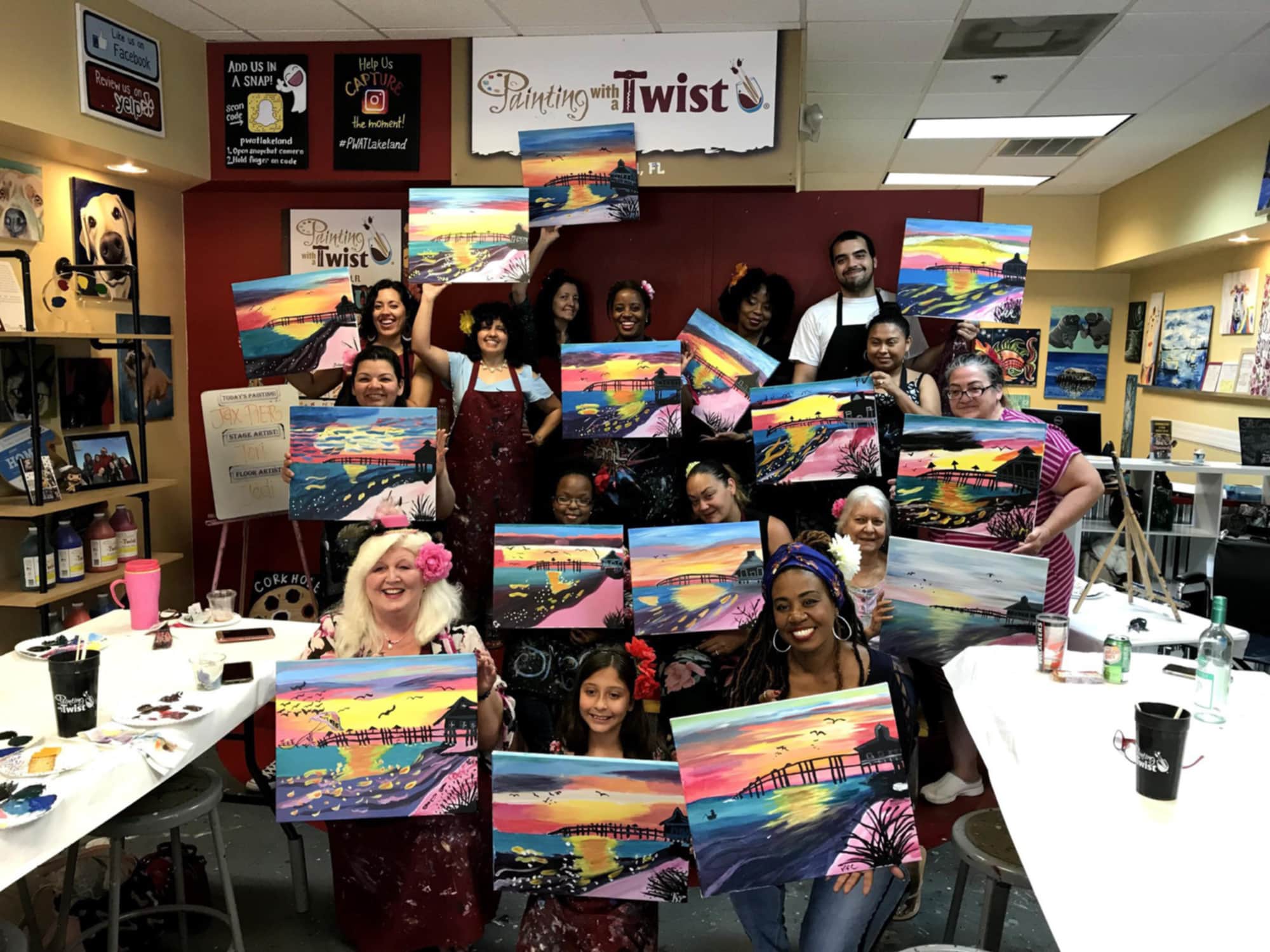 Group with finished paintings at Painting with a Twist in Lakeland, FL