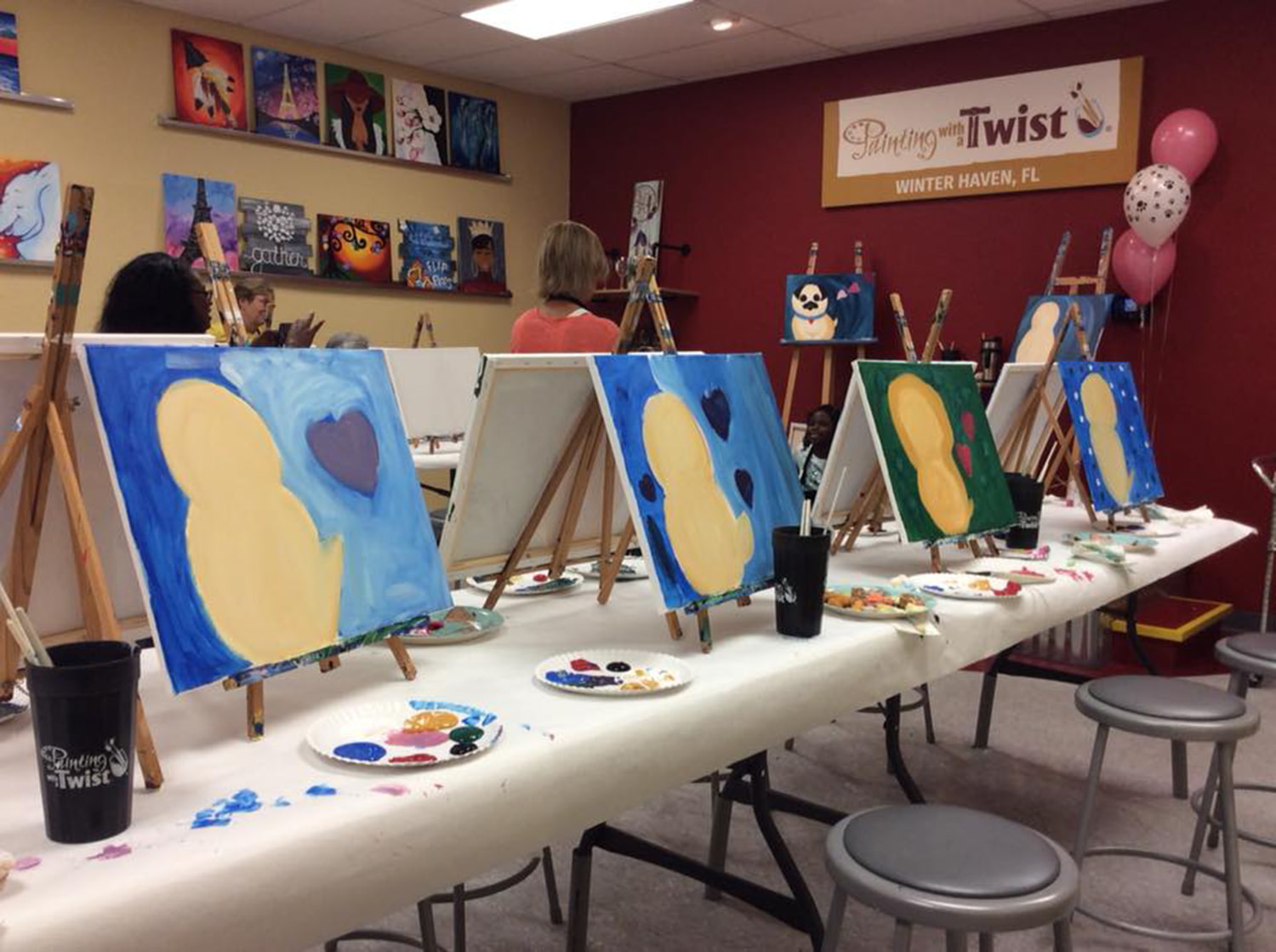 Participant paintings on table during class at Painting with a Twist in Winter Haven, FL