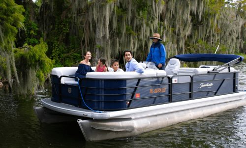 family of four on pontoon boat during tour with The Living Water Boat Cruises in Winter Haven, FL