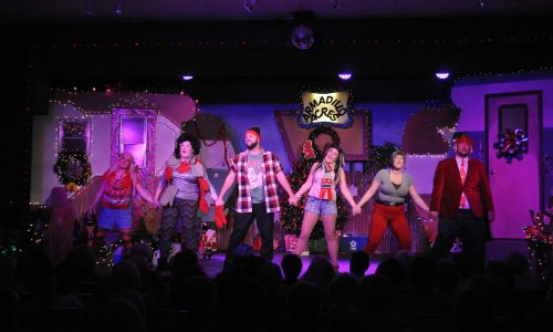 Actors on stage during Christmas themed performance at TheatreWorks Florida in Davenport.