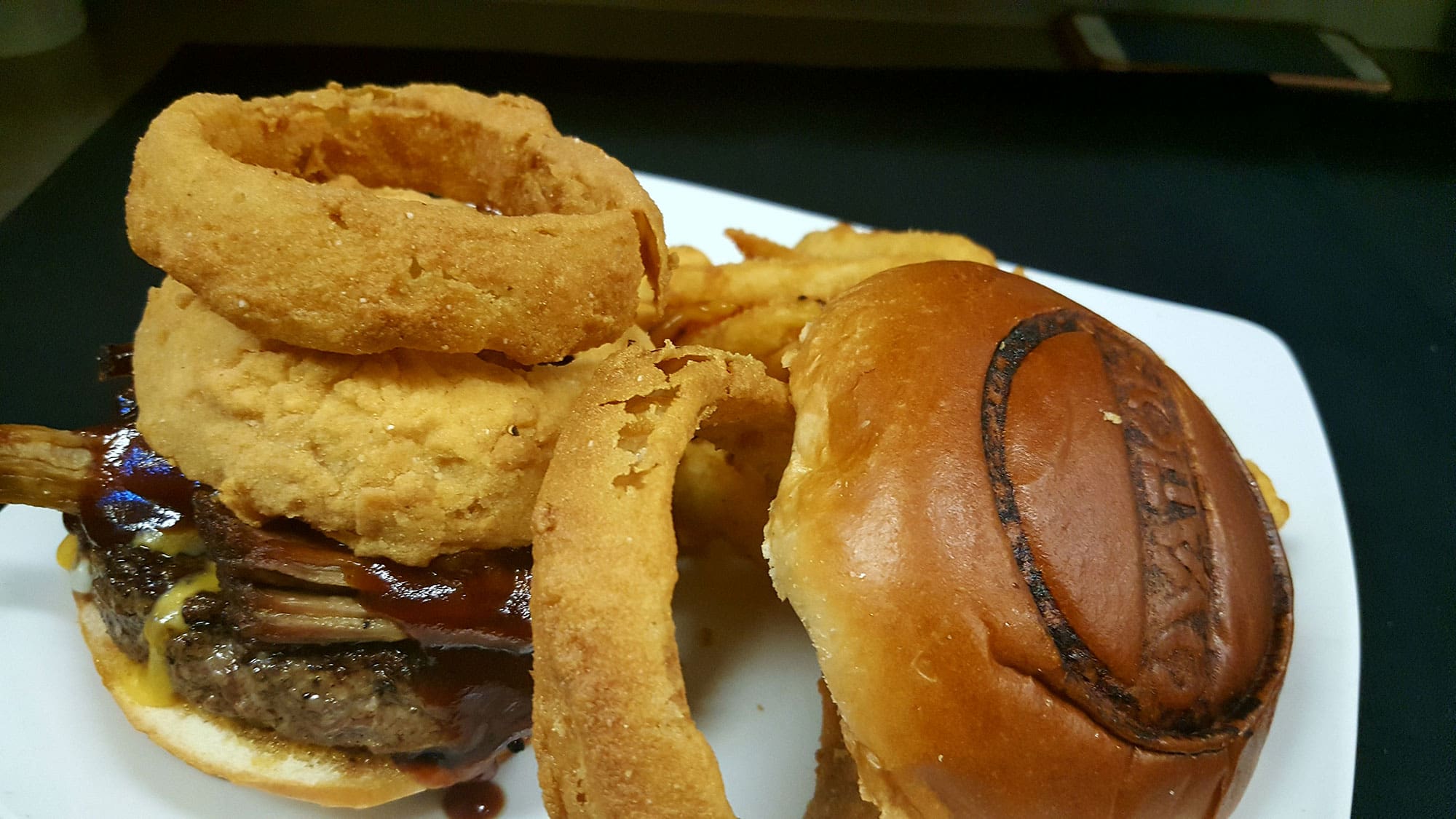 hamburger with beef, pork rib and onion rings at Ovations