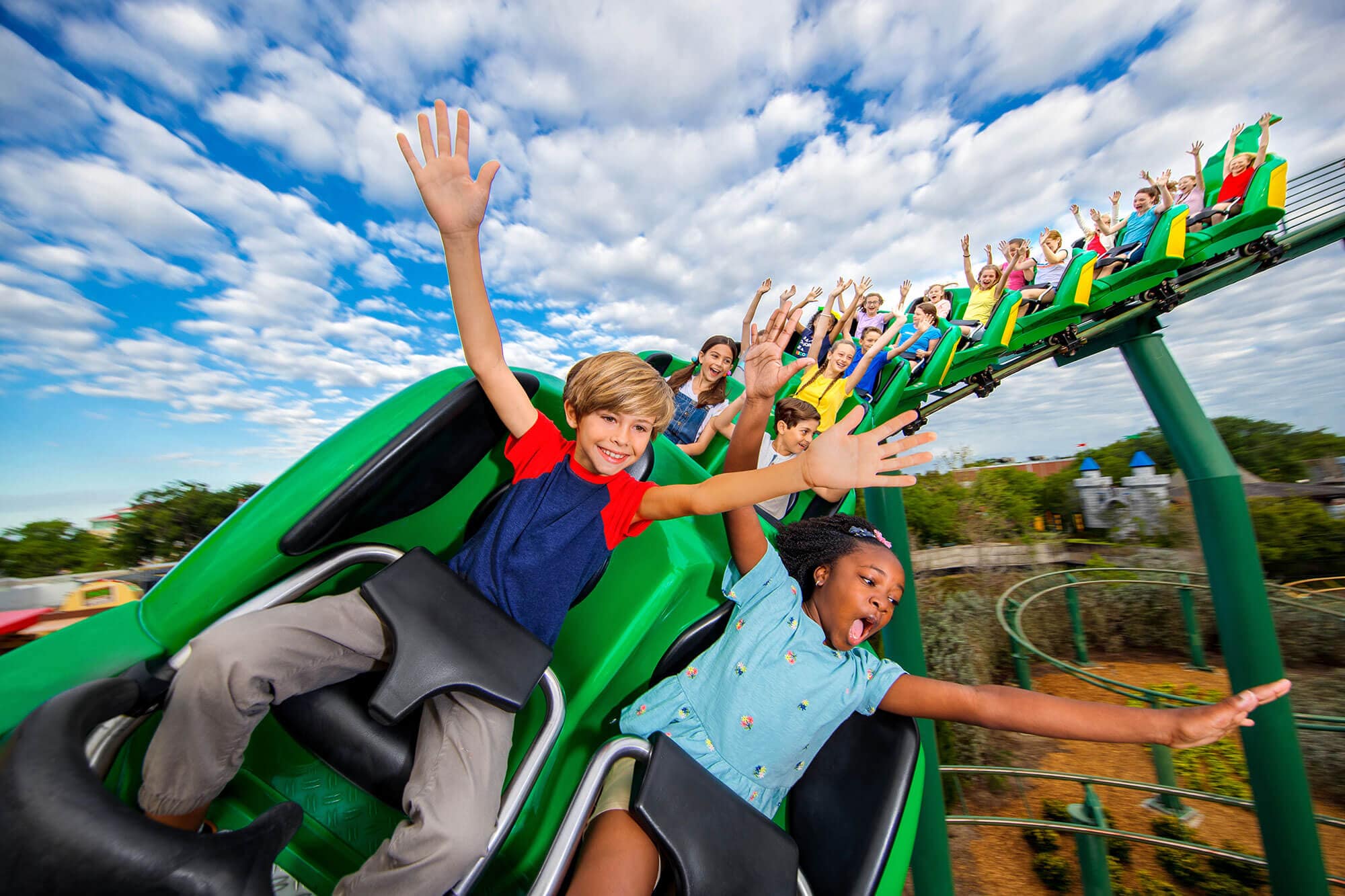 kids with hands up on Dragon Coaster Ride at LEGOLAND Florida Resort in Winter Haven, FL
