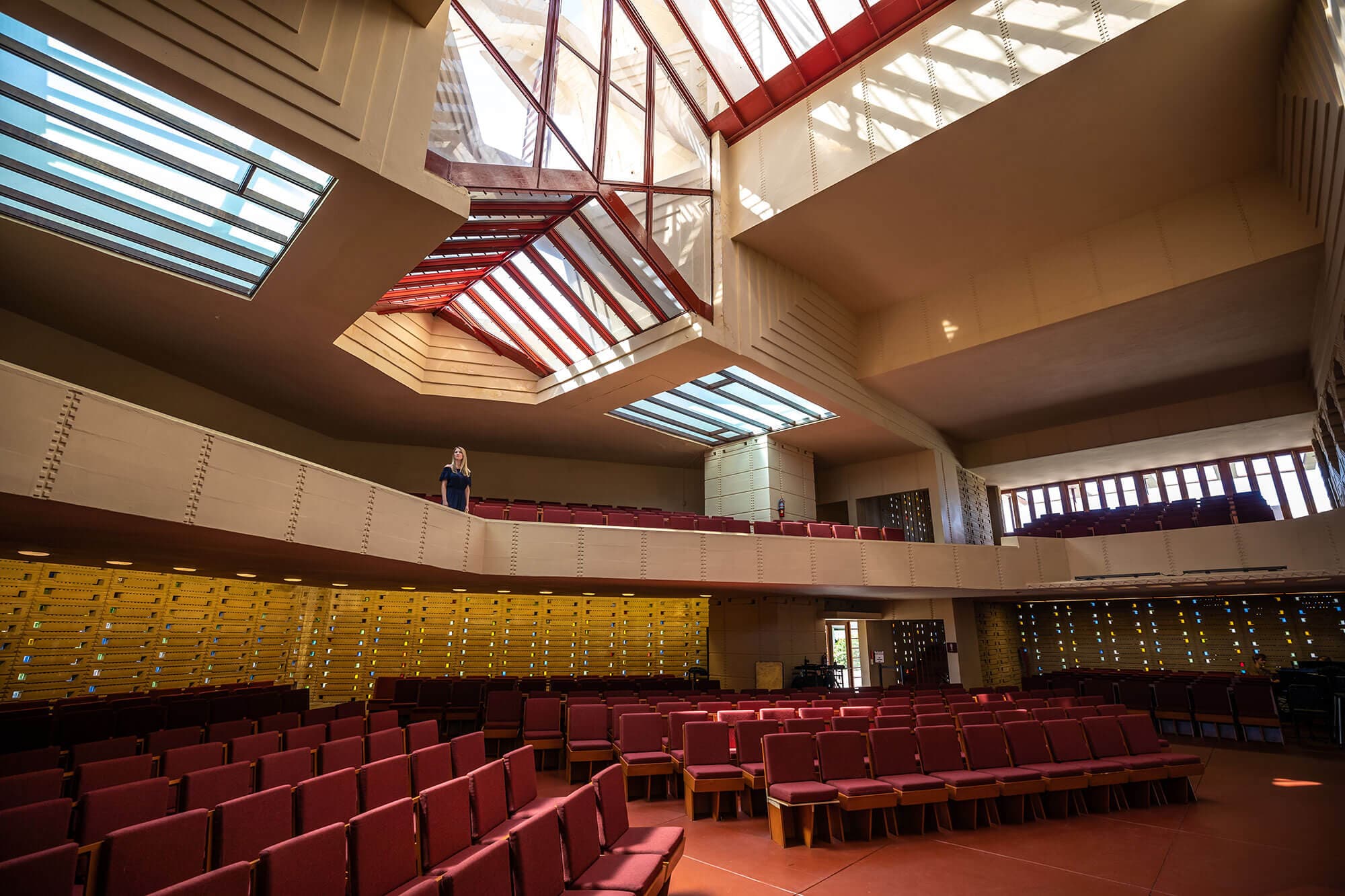 Inside Frank Lloyd Wright's Annie Pfeiffer Chapel at Florida Southern College in Lakeland, FL. Woman standing in balcony seating area.