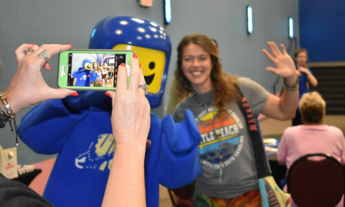 CATS training session attendee taking photo with LEGOLAND Florida Resort character