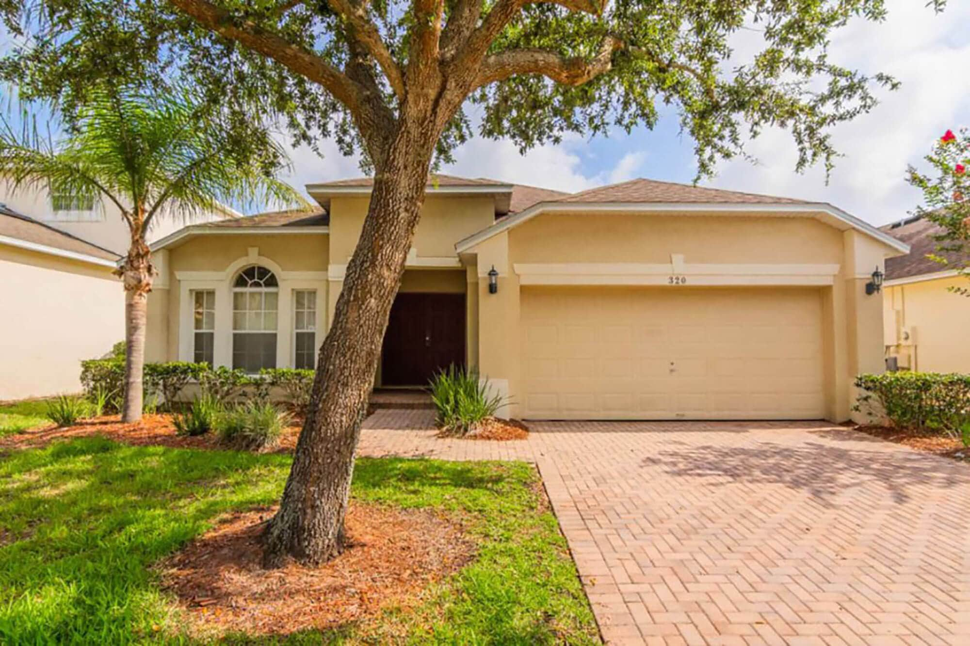 exterior of single story home with two car garage, a Florida Villas Direct vacation rental home in Davenport