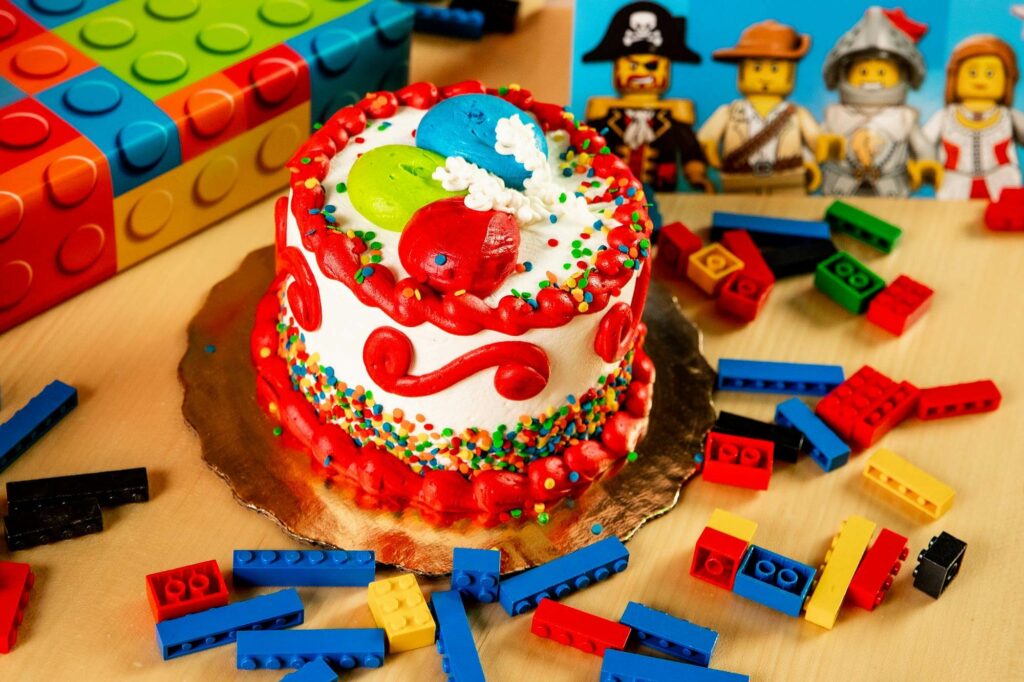 birthday cake with legos and lego pirates in background