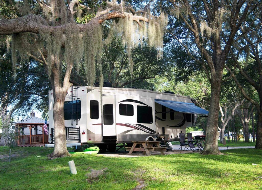 RV Motorhome on shaded campsite at Camp Mack, a Guy Harvey Resort in Lake Wales, FL 