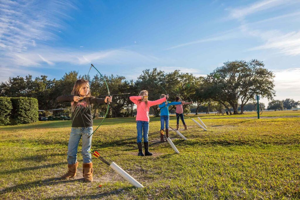 4 kids shooting arrows at Westgate River Ranch Resort near Lake Wales, FL