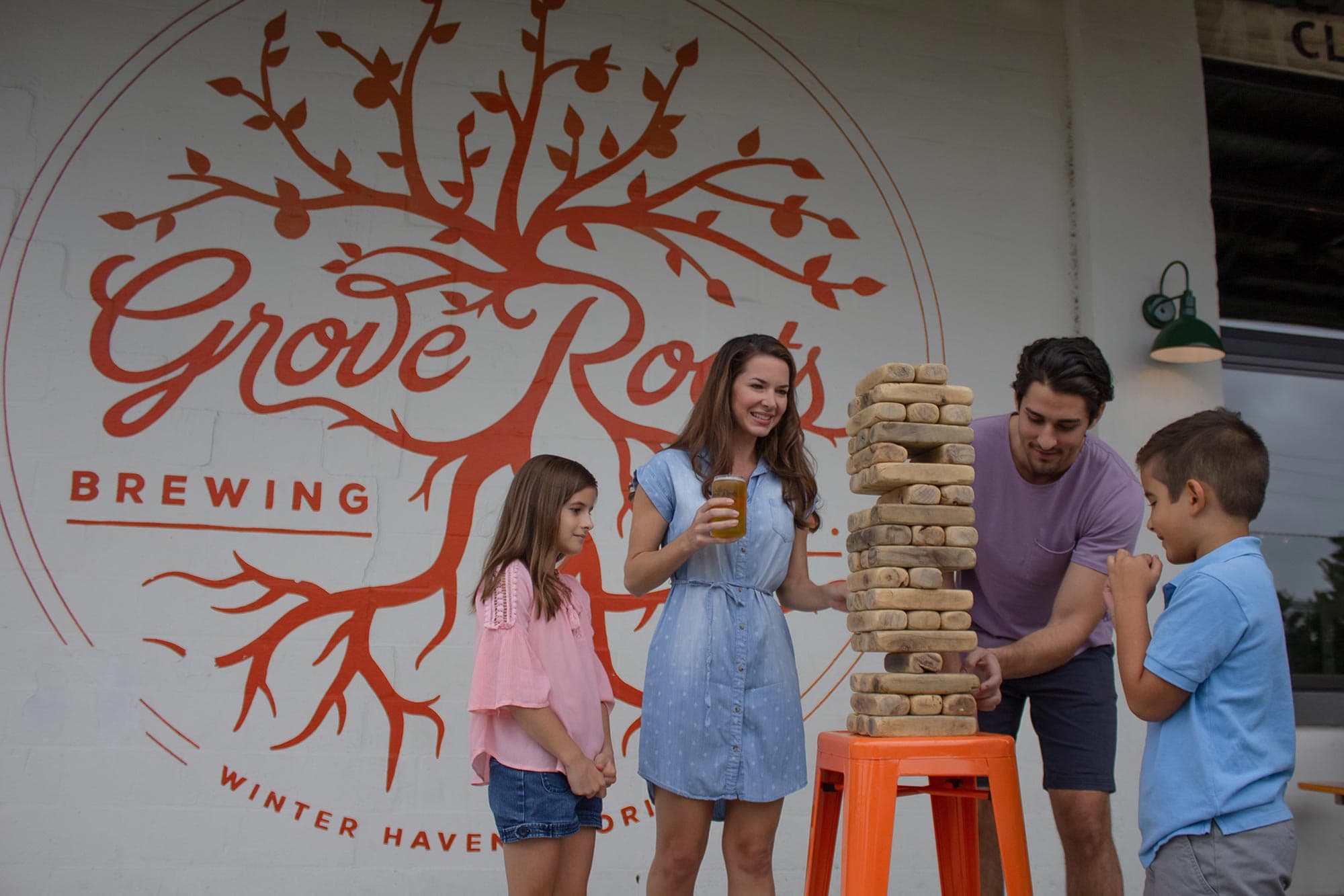 family playing Jenga at Grove Roots Brewing Co. in Winter Haven, FL